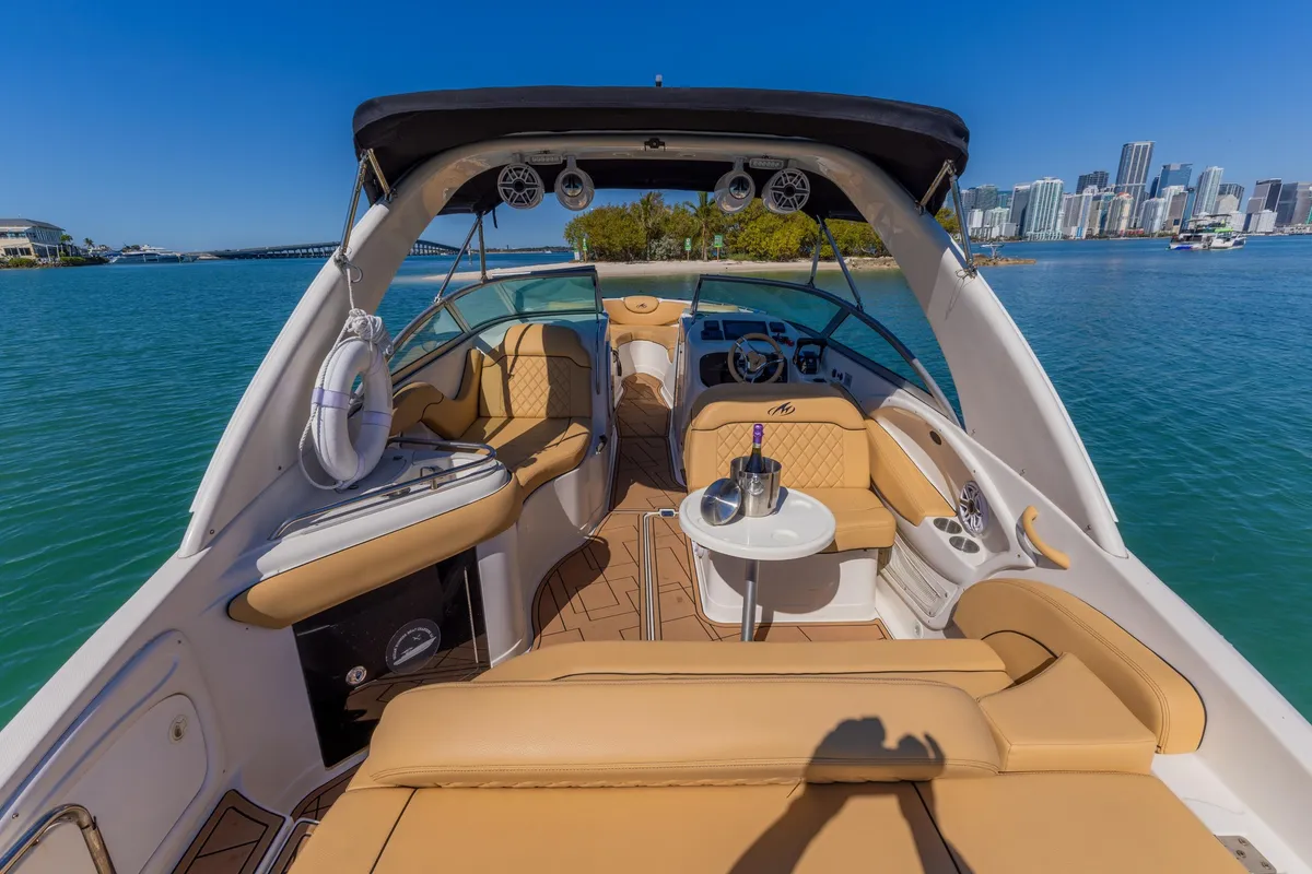 Guests relaxing on the bow during an exclusive private boat tour in Miami passing Millionaire's Row waterfront mansions